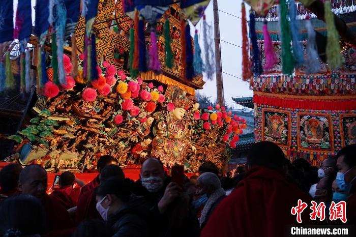 图为游客观赏塔尔寺酥油花展，并用手机记录。　马铭言 摄